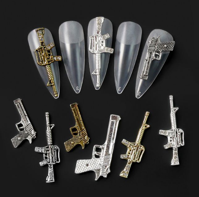 weapon-shaped nail charms display - 2
